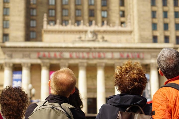 Tourists under the Palace of Culture and Science