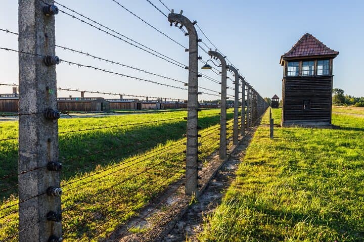 Barbed wire and guard tower at Auschwitz II Birkenau concentration camp