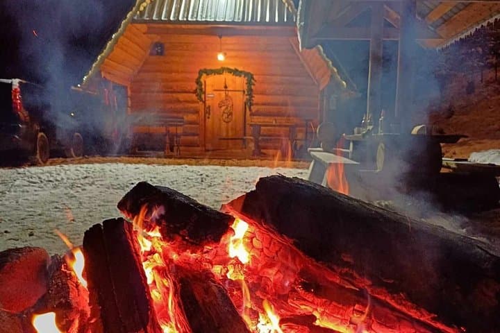 Sled ride pulled by horses with bonfire and dinner.